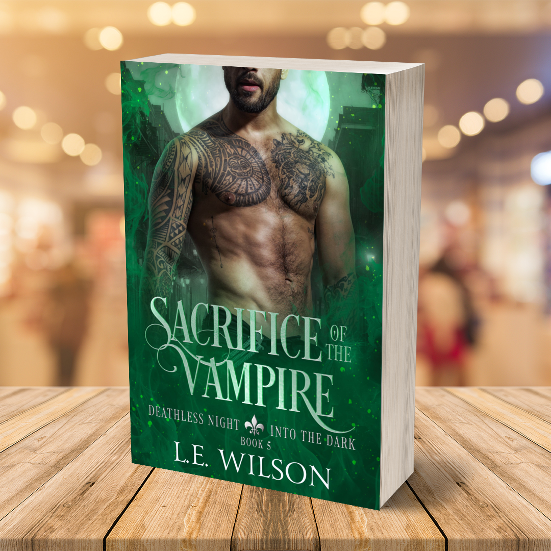Book titled 'Sacrifice of the Vampire' by L.E. Wilson on a wooden surface with a blurred background