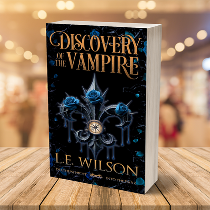 Book titled 'Discovery of the Vampire' by L.E. Wilson on a wooden surface with a blurred background