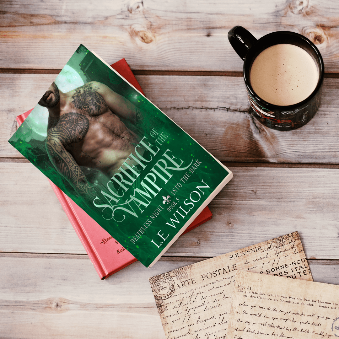 Book titled 'Sacrifice of a Vampire' by L.E. Wilson with a mug of coffee on a wooden surface.
