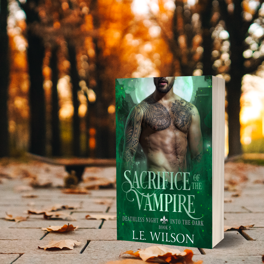 Book titled 'Sacrifice of the Vampire' by L.E. Wilson on a brick surface with a forest background.